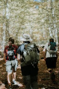 people walking on dirt road